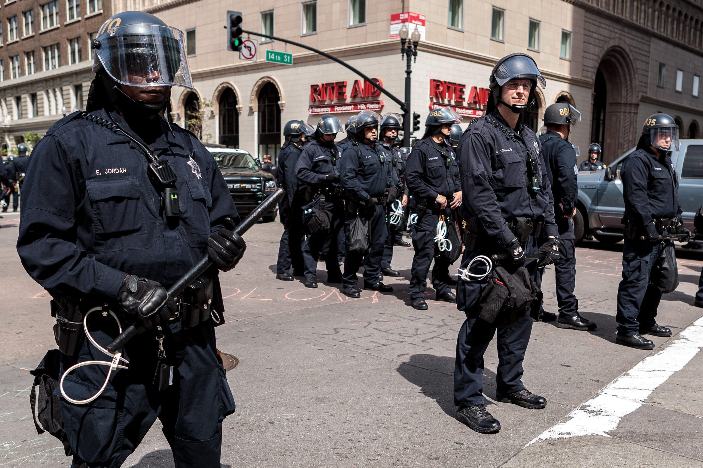 Oakland police officers wearing protective gear stand at 14th and Broadway Streets in Oakland, California during a protest on May 1, 2012.