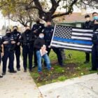 Members of the Vallejo Police Department, including Chief Shawny Williams, Deputy Chief Michael Kihmm, and Captain Jason Potts pose for a photograph with the controversial "Blue Lives Matter" flag, which has been criticized for its associations with the white supremacist movement. The Vallejo Police Department posted the image to its official social media accounts on Dec. 25, 2020, but deleted it from Twitter following criticism. The photograph remains on the department’s official Facebook and Instagram pages.