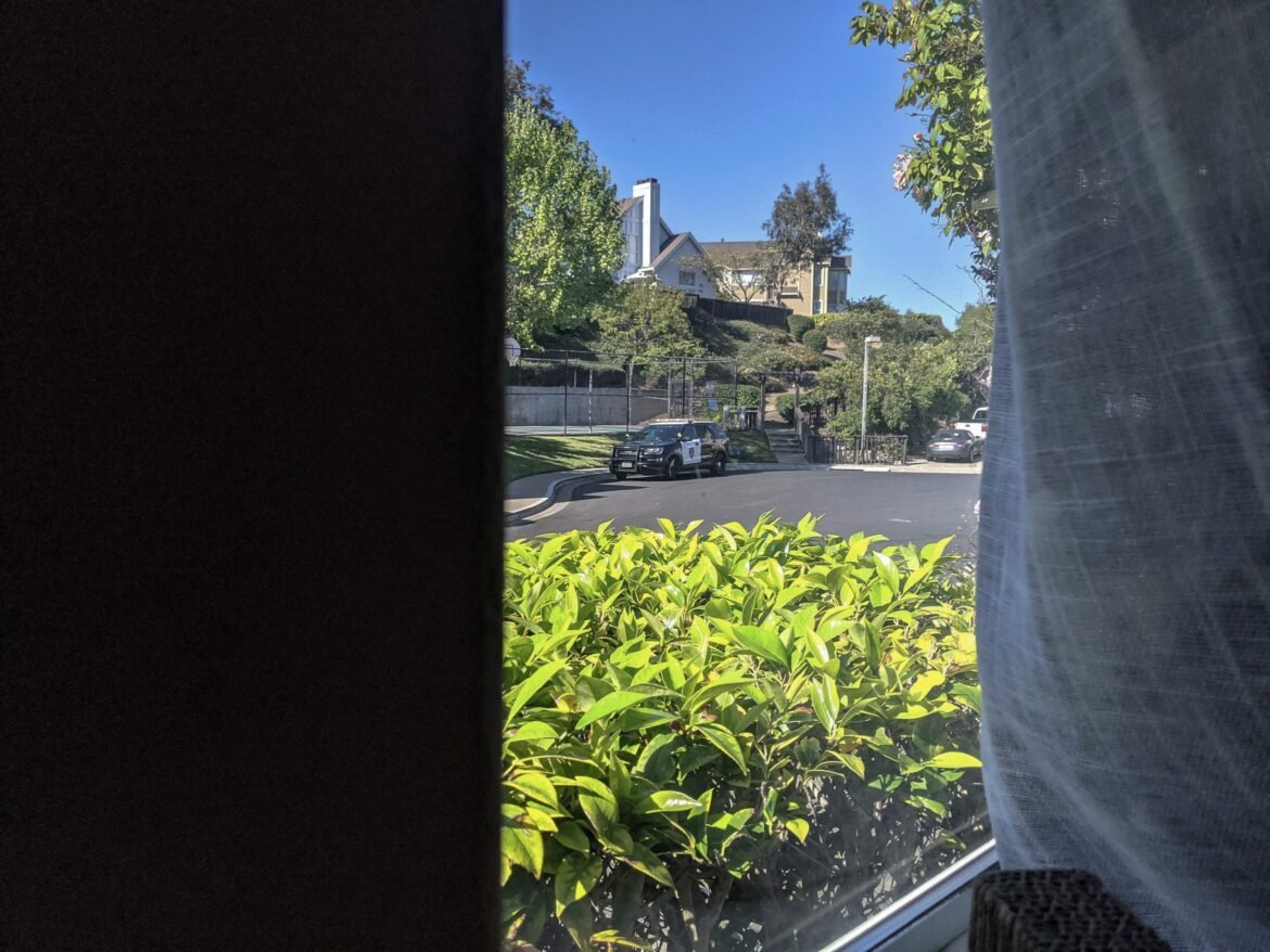 A Vallejo Police Department SUV is seen parked outside fired City Hall employee Slater Matzke's home. The photograph was taken through a window from inside the home.
