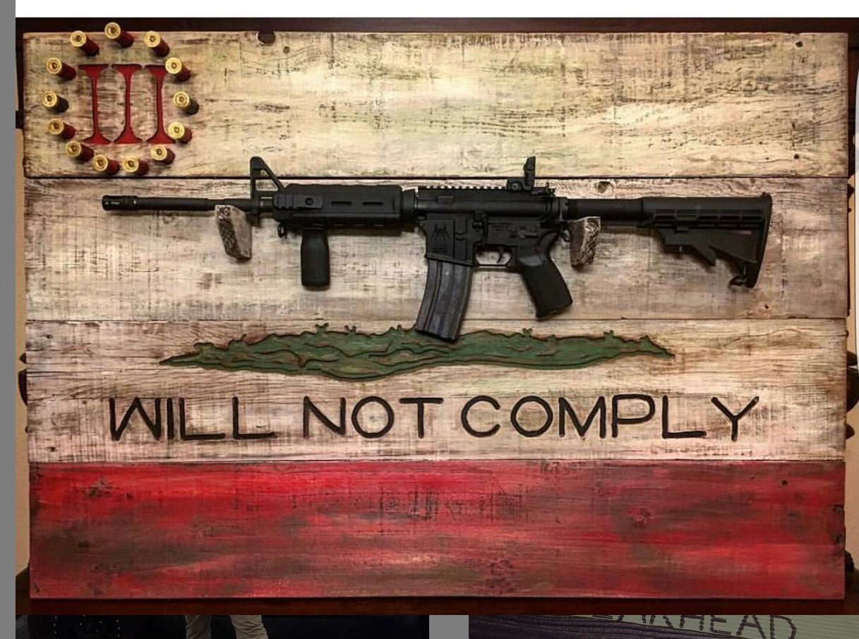 An AR-15 rifle on a display rack bearing the words, "WILL NOT COMPLY" and the logo of the Three Percenters, a far-right militia linked to violence across the country.