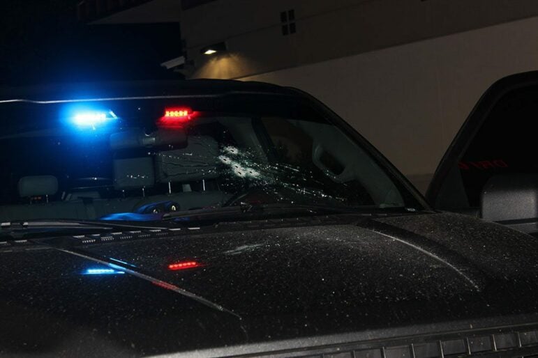An closeup of an undercover Vallejo police pickup truck with five bullet holes in the windshield, fired from inside the vehicle.