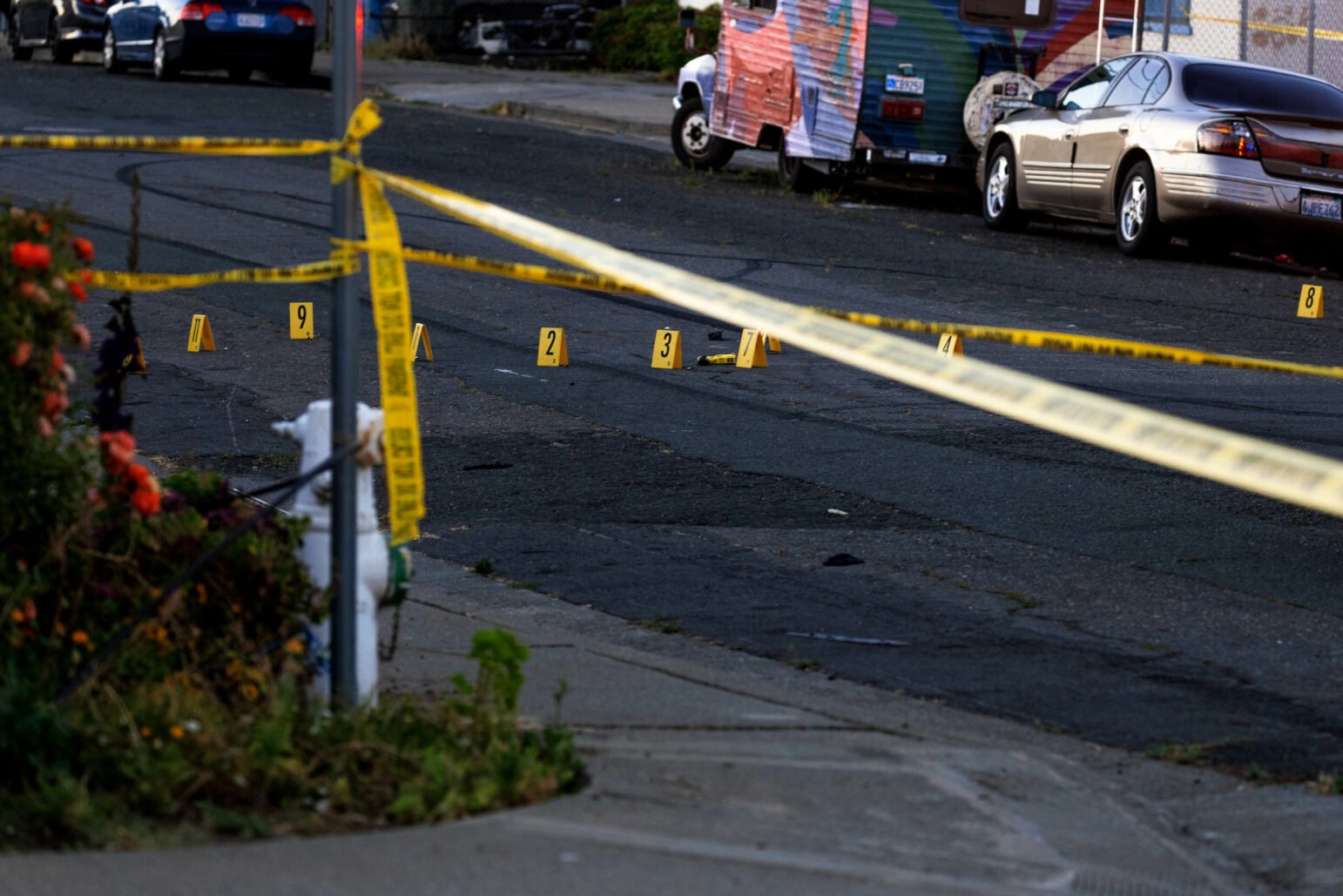 A Taser lies behind crime scene tape outdoors at dusk