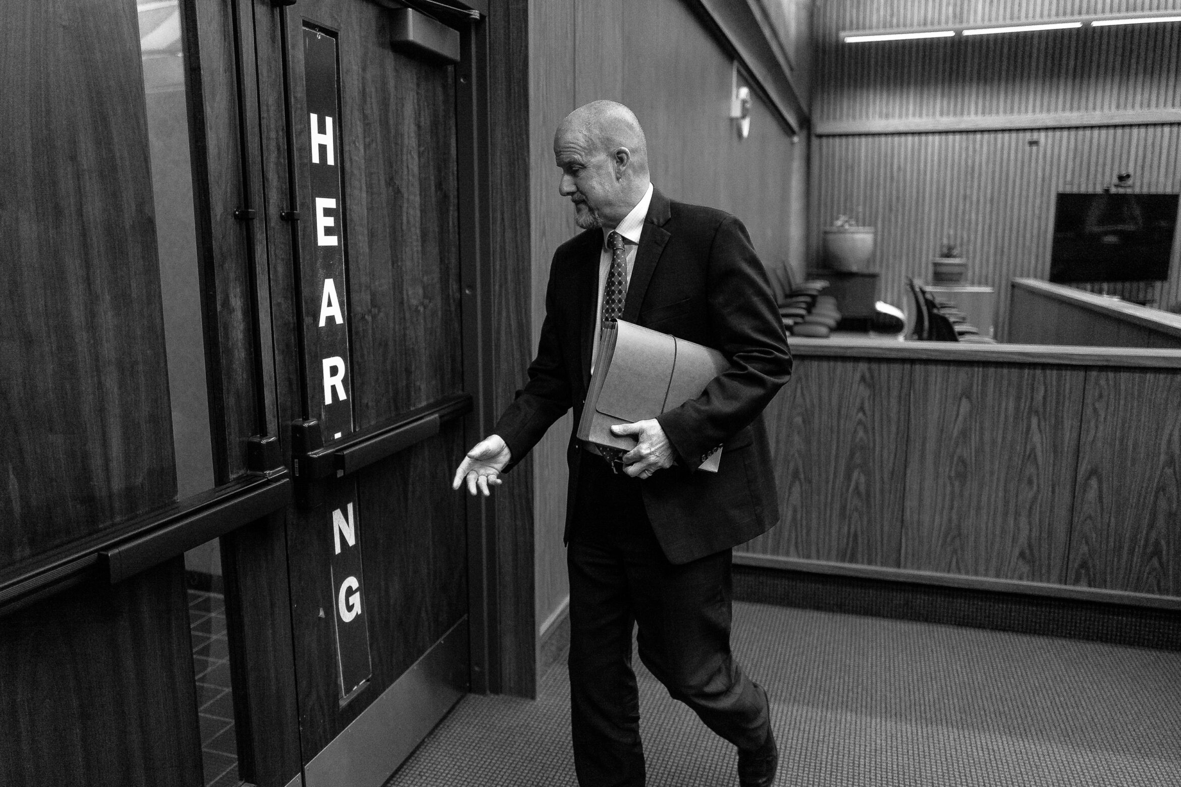 A white male lawyer with a shaved head in his 50s or 60s leaves a hearing in Solano County Superior Court.