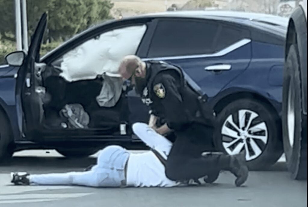 A Vallejo police officer, who is white, detains a Black woman who he then punched in the face after her car collided with an SUV and a cement truck.