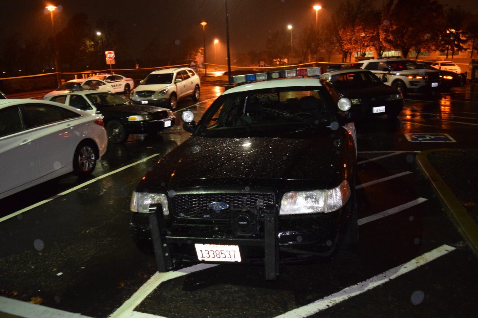 Vallejo Police Ofc. Jeremey Callinan's police car and two Fairfield police cars are seen in the rain at night.
