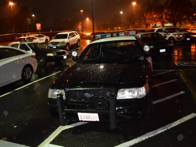 Vallejo Police Ofc. Jeremey Callinan's police car and two Fairfield police cars are seen in the rain at night.