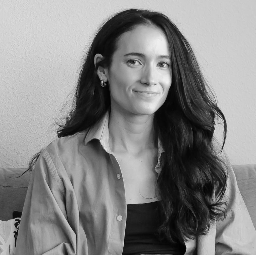 A black and white professional headshot of Sarah Hopkins.
